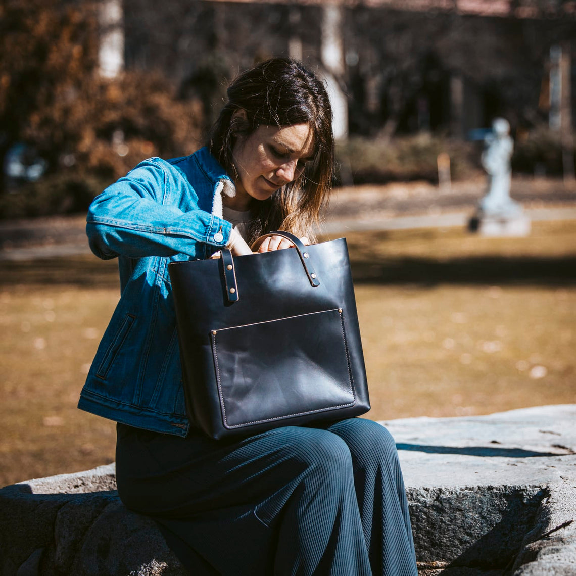 Black leather tote carried in the park