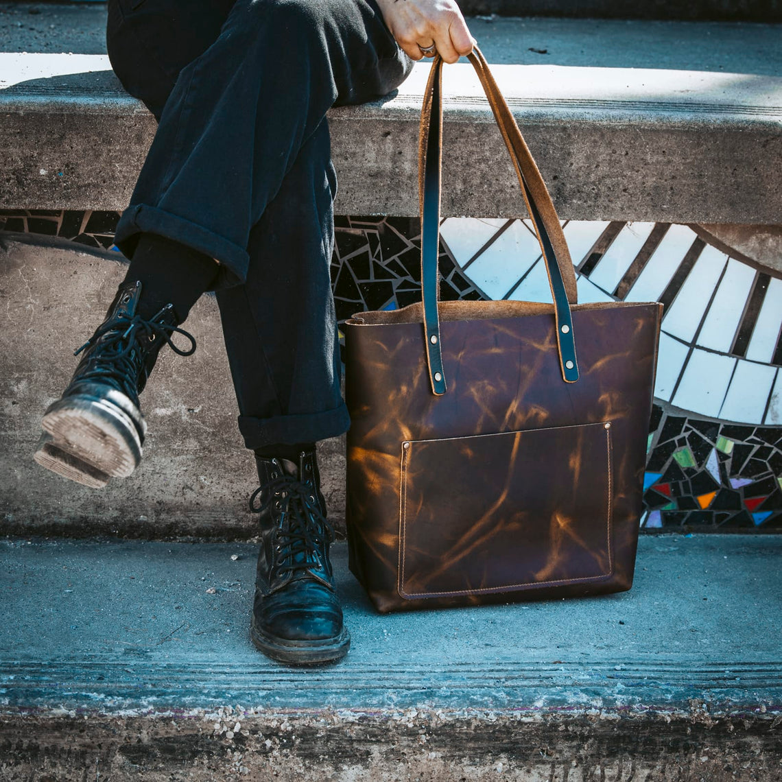Heritage Brown leather tote held by the handles
