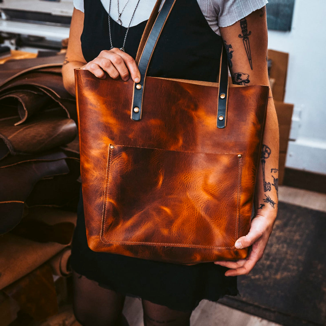 English Tan leather tote held in the Popov Leather workshop