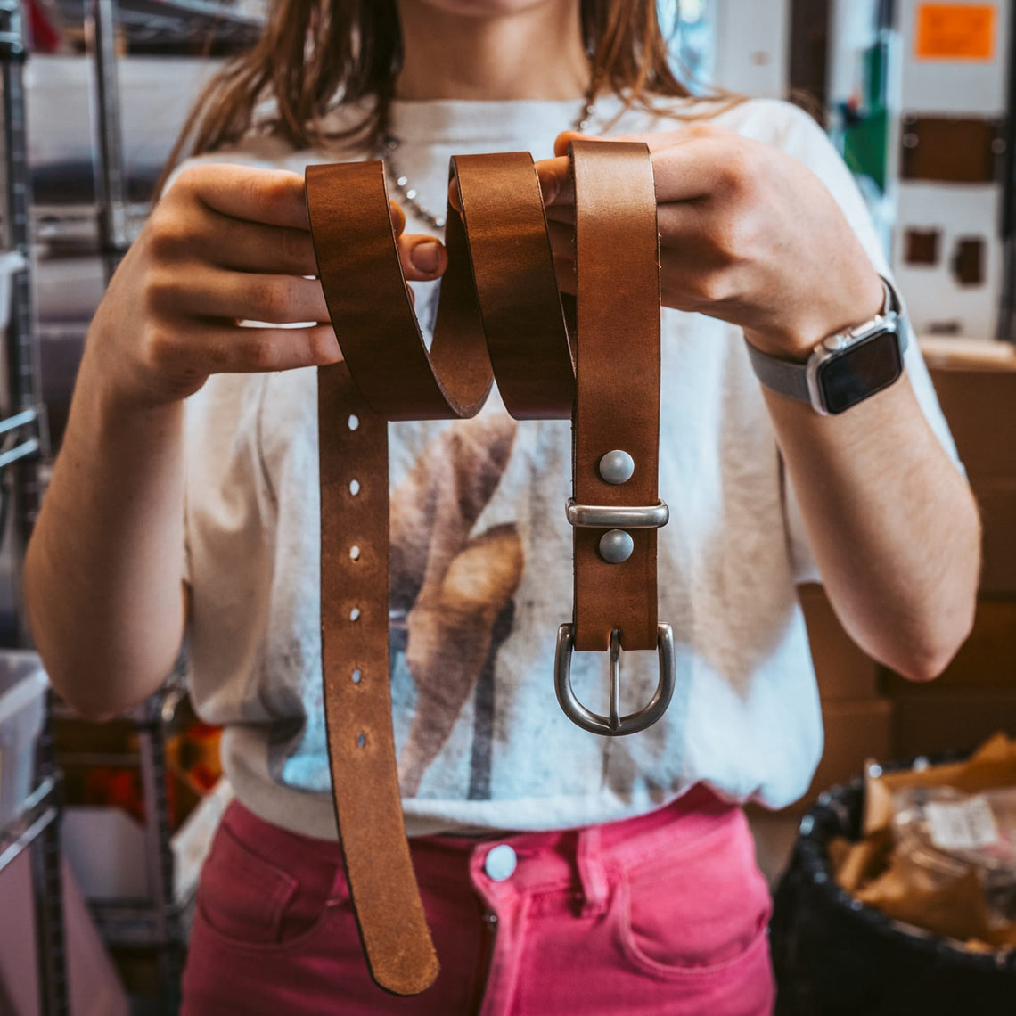 Rounded brass buckle on a women's leather belt